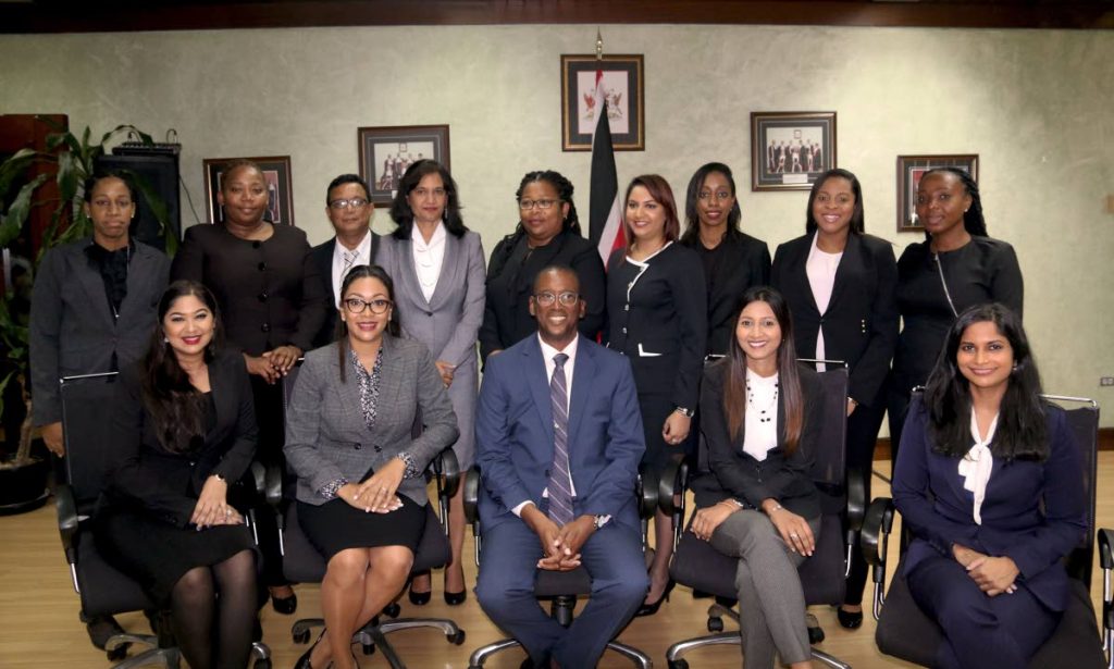 Chief Justice Ivor Archie, center, with the newly sworn in magistracy registrars and clerks of the court at the Hall of Justice in Port of Spain.