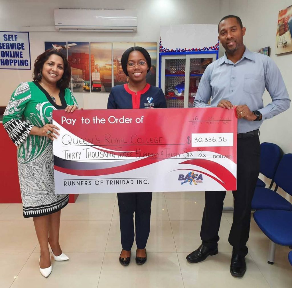 Doctor Safeeya Mohammed of Sisu Global Wellness, left, Victoria Sealey of Trinebox, middle, and Nigel Bellamy of Bafasports with the cheque that was presented to QRC.