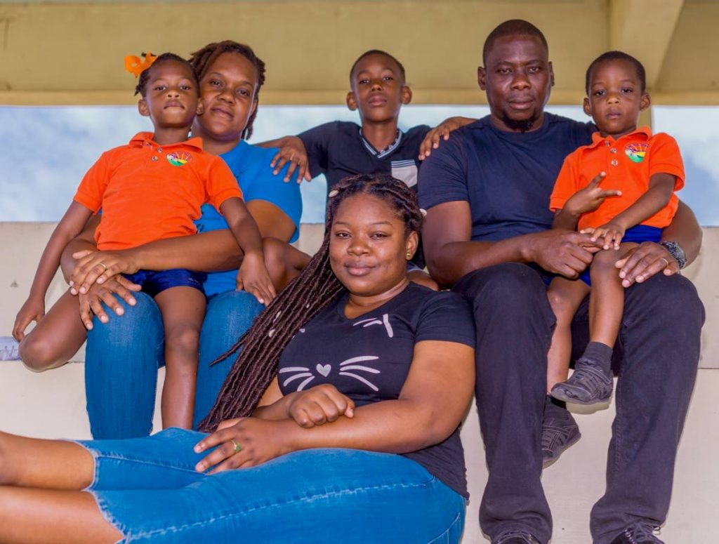 Ryan Stewart with his family, from left, daughter N'Kaylia, wife Sherrena, son Ayden, daughter Camelia, and son Zico at their home in Patience Hill, Tobago. PHOTO BY DAVID REID