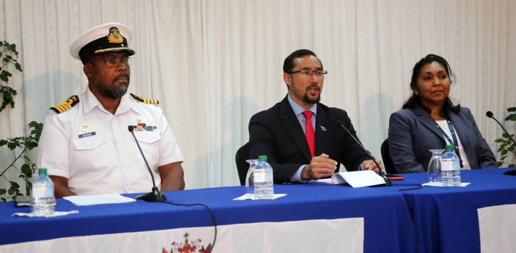 National Security Minister Stuart Young flanked by Captain Douglas Archer Ag Chief of Defence Staff,  left, and acting Chief Immigration Officer Charmaine Gandhi-Andrews during a press conference on the Venezuelans registration at the Ministry’s head office on Abercromby Street, Port of Spain, yesterday. 
