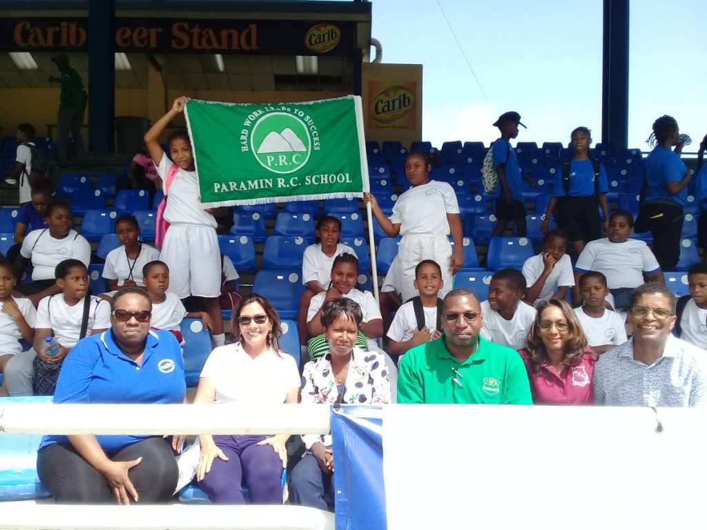 Paramin RC students, back, celebrate after winning the tournament. Also in the photo are lady of assumption at Boissiere RC Letticia Noreiga-Phillip, from left sitting, president of the Rotary Club of Maraval Jennifer Abraham, curriculum officer physical education and sport at the Ministry of Education Shelly Slater, La Seiva RC principal Benil Niles, Maraval RC principal Kathleen Merhair-Gransam and Paramin RC principal Camillus Olivier.