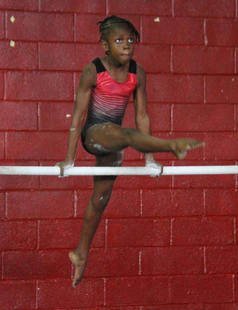 TT’s Dahlia Burke goes through her routine on the uneven bars, at the Caribbean Gymnastics Championships, Woodbrook Youth Facility, yesterday.