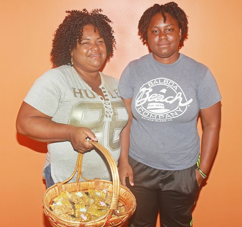 Nakeisha Simon, left, and daughter Makeisha Simon, 21 are selling nuts to raise funds after Makeisha was accepted to UWI for a bachelor’s degree in medicine and surgery starting in September.