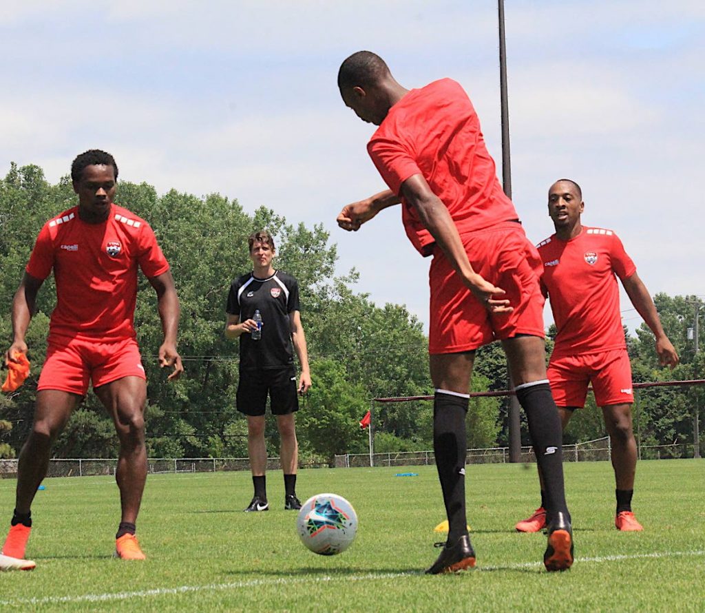 TT's Levi Garcia, left, Kevan George, centre, and Leston Paul, right, take part in a training session ahead of their Gold Cup opener against Panama tomorrow. PHOTO BY TTFA MEDIA 
