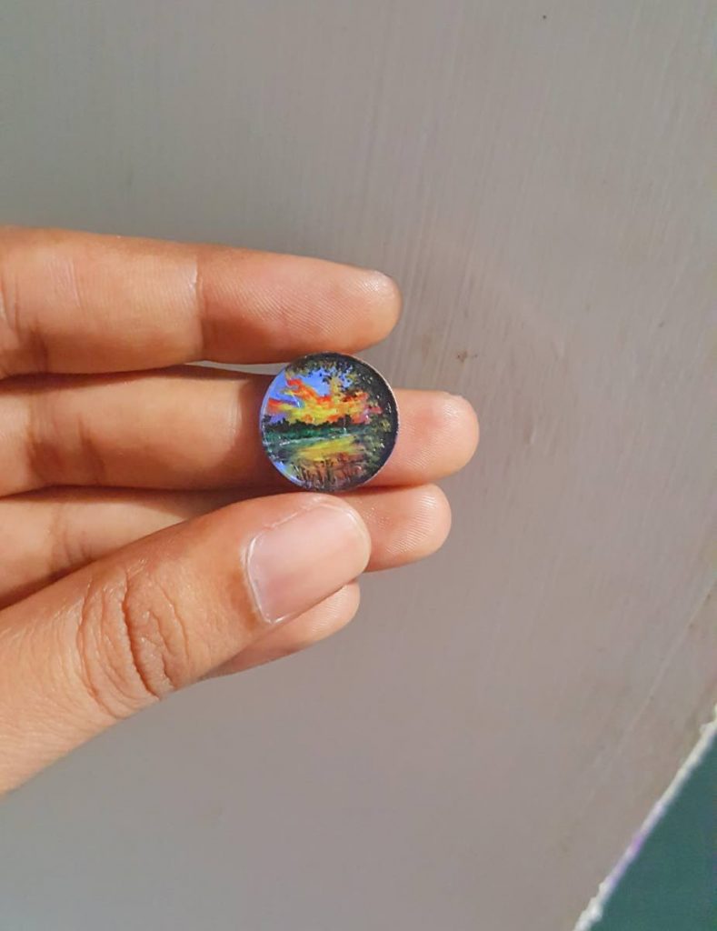  The acrylic painted one cent piece shows the sunset at Caroni River. 