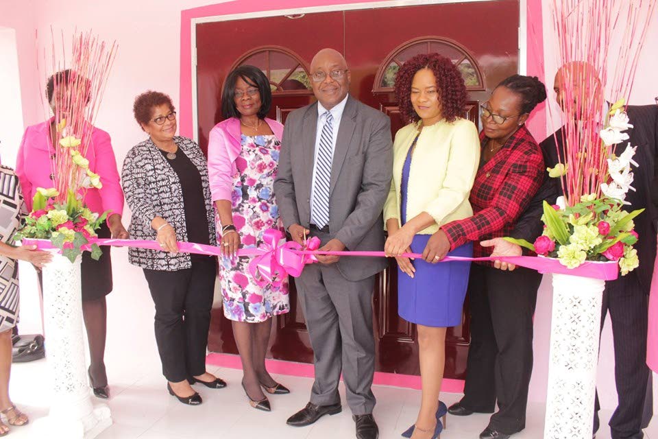 Chief Secretary Kelvin Charles, centre, cuts the ribbon to open the Women's Health Service/Pink Room and Breast Health Clinic at Windward Road, Louis D'or. 