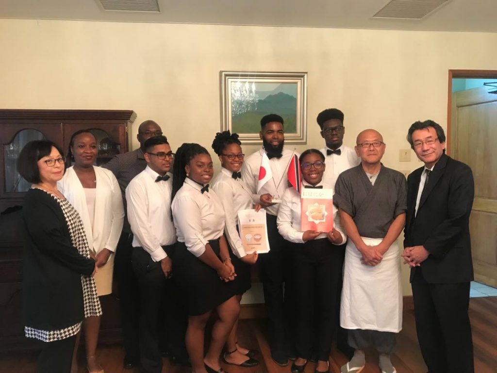 Japanese ambassador Tatsuo Hirayama, right, and his wife, Sachiko Hirayama, left, with resident chef Jinich Osawa, second from right, TTHTI students, student coordinator, Renatta Francis, second from right, and TTHTI chef Virges Lovelace, at back.