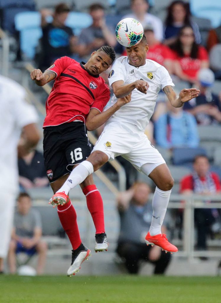 Trinidad and Tobago's Alvin Jones (#16) vies for the ball with Panama's Gabriel Torres during the first half of a CONCACAF Gold Cup game on Tuesday in St Paul, Minnesota. (AP PHOTO)