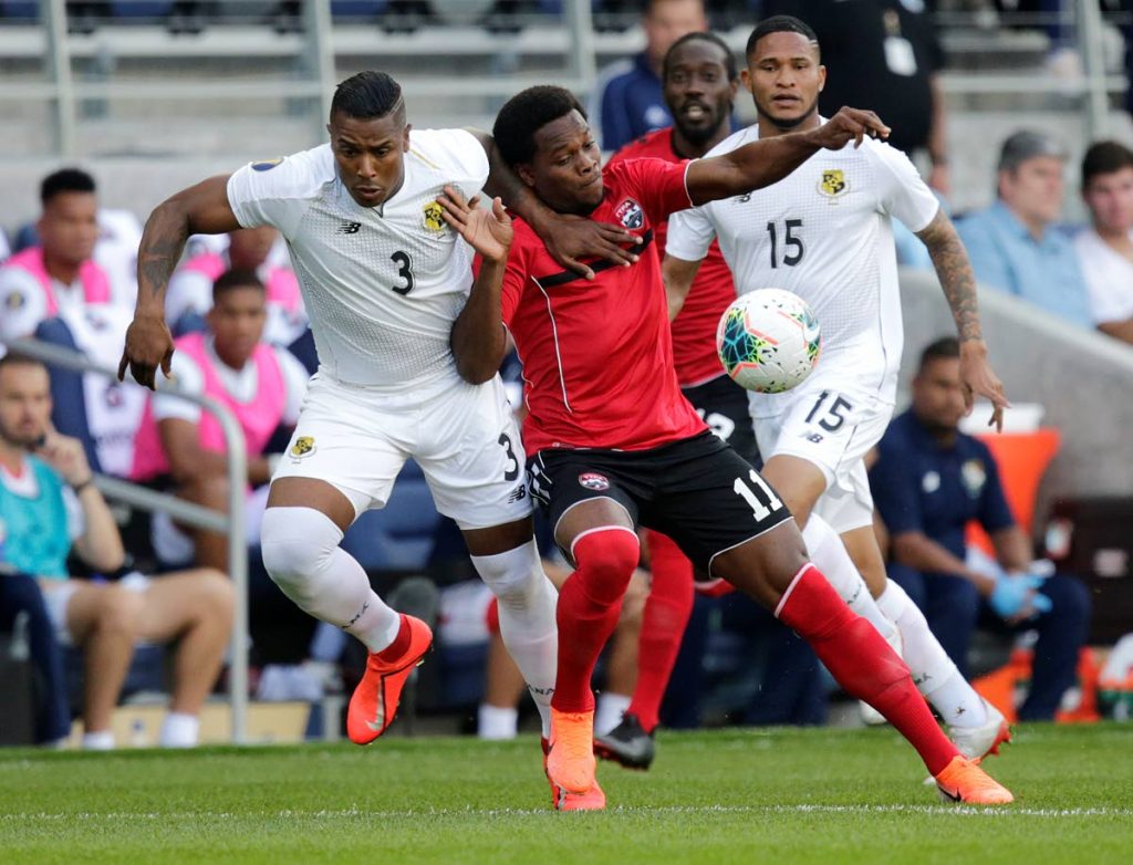 Trinidad and Tobago’s Levi Garcia (#11) battles for the ball with Panama’s Harold Cummings during the first half of a CONCACAF Gold Cup game on Tuesday in St Paul, Minnesota. (AP PHOTO)