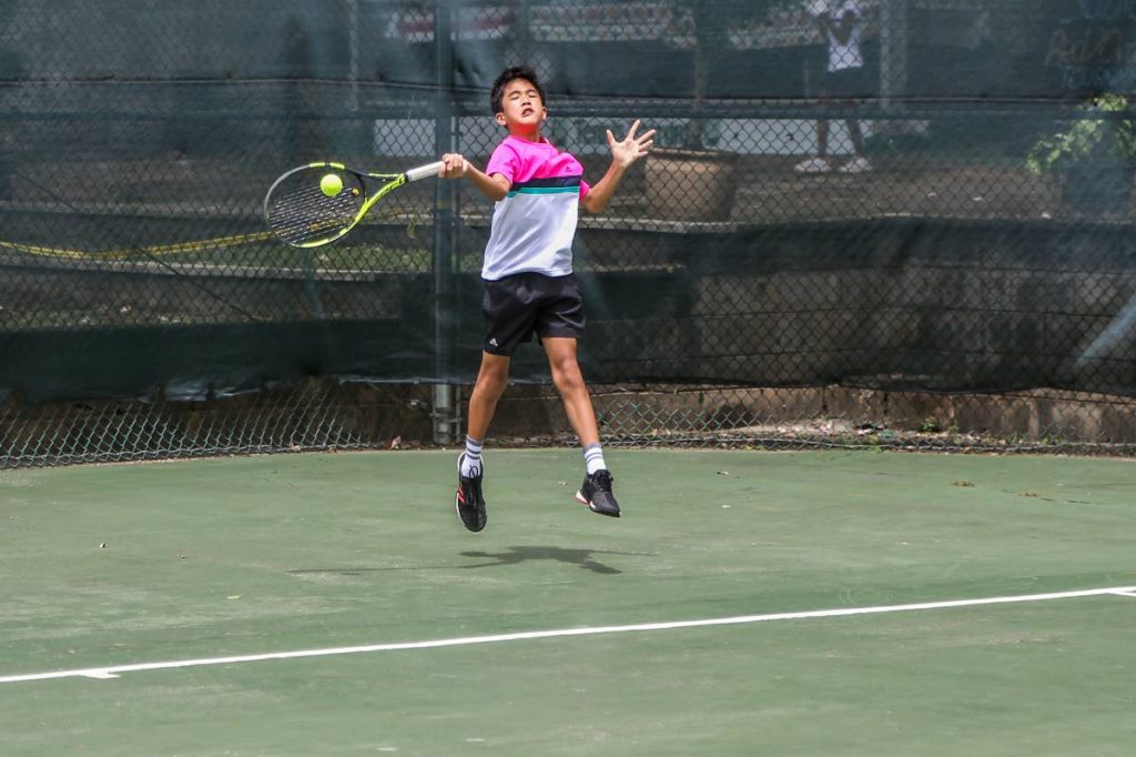 Tim Pasea attempts a forehand in the boys 14 and Under Singles round robin. 