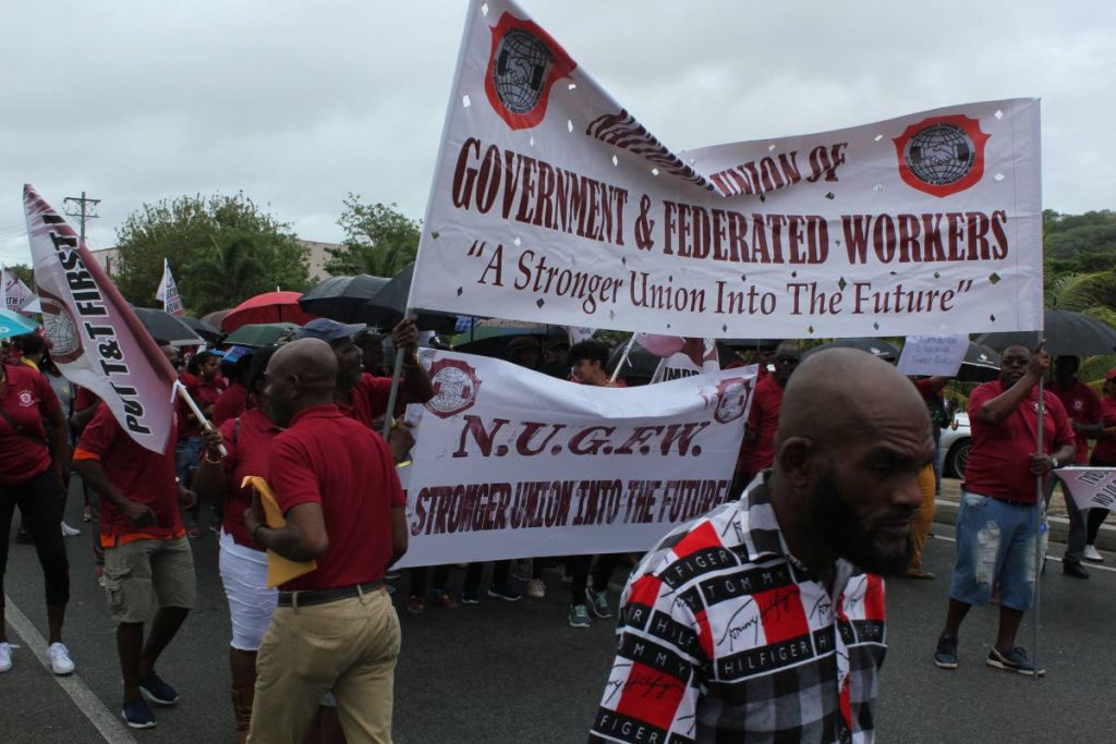 National Union of Government and Federated Workers members march through Scarborough at Labour Day celebrations on Wednesday. PHOTO BY SAMUEL SAMAROO
