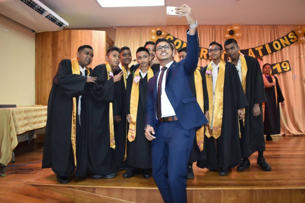 Councillor for Reform/Manahambre Chris Hosein takes a photo with the Reform Hindu School graduating class of 2019.