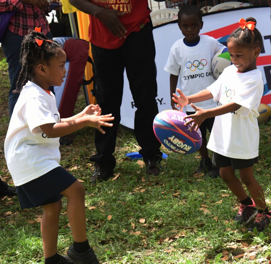 Children from First Step Child Care Centre enjoy a game of rugby during Olympic Day 2019 at Lord Harris Square, Port of Spain, yesterday. 