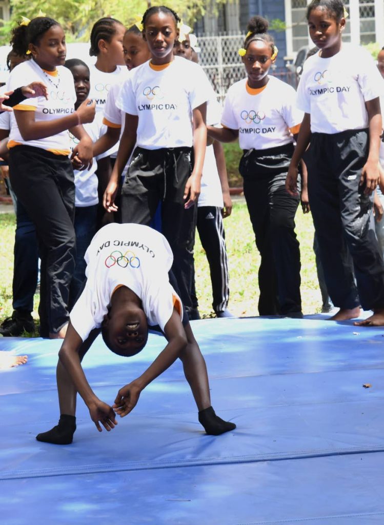 A young gymnast has the attention of other children at Olympic Day 2019 at Lord Harris Square, Port of Spain, on Friday. 
PHOTOS BY KERWIN PIERRE