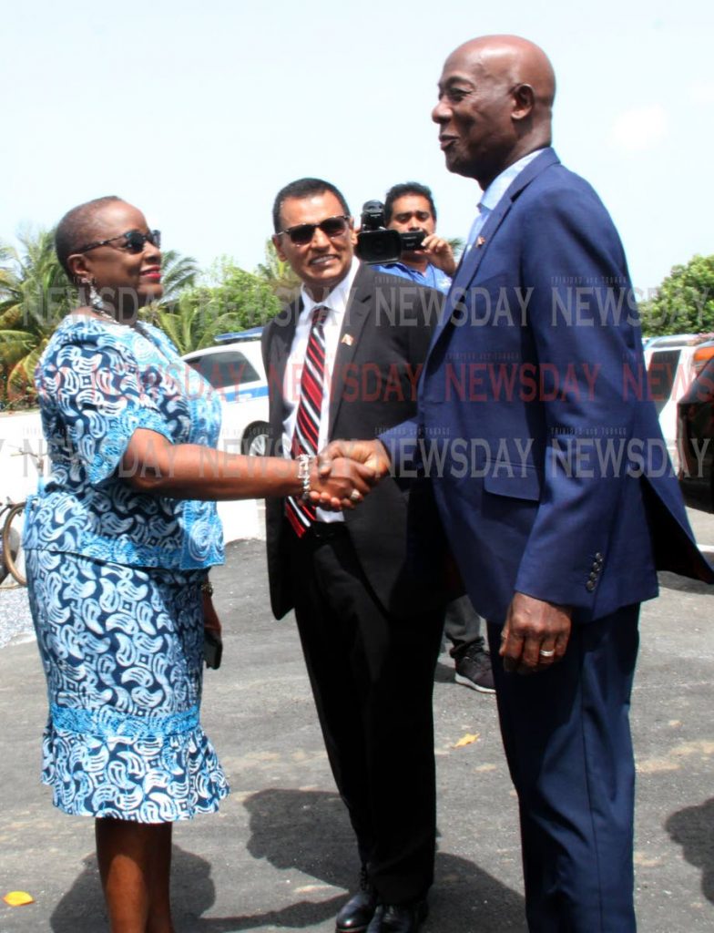 Prime Minister Dr Keith Rowley, right, greets Minister of Planning Camille Robinson1-Regis on his arrival at the opening of the Chaguanas Traffice Plan on Friday. Looking on at center is Minister of Works Rohan Sinanan. PHOTO BY VASHTI SINGH