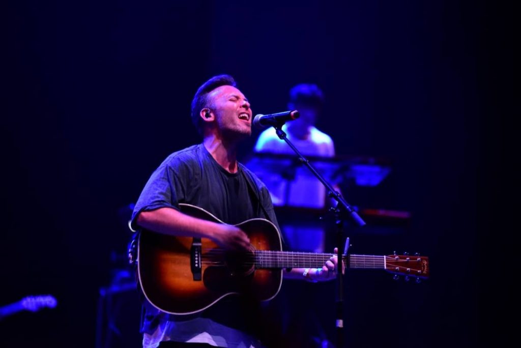 A Hillsong London member sings and plays the guitar at Glow Fest 2019. 