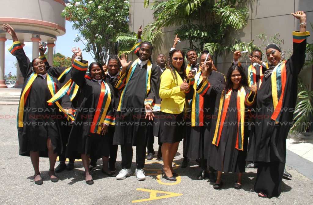 Parliamentary Secretary in the Ministry of National Security Glenda Jennings-Smith, 
centre, poses with students of the Civilian Conservation Corps (CCC) during their graduation 
which at the Torenia Hall, Centre of Excellence, Macoya, on Wednesday, PHOTO BY AYANNA KINSALE