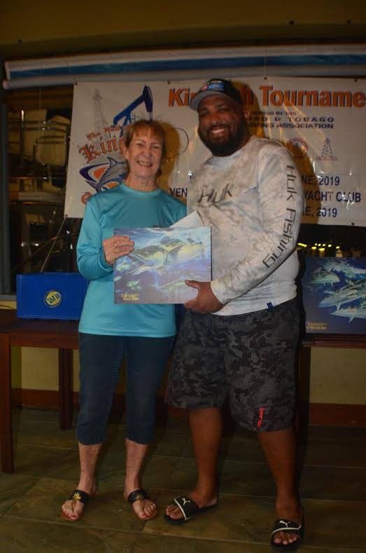 Rishi Ramnath from Team Reel Tackle, right, receives his award for Best Male Angler from Marylin Sheppard, vice-president of TT Game Fishing Association, following the recently-staged  13th annual Well Services Group of Companies Kingfish Tournament at the TT Yacht Club.  