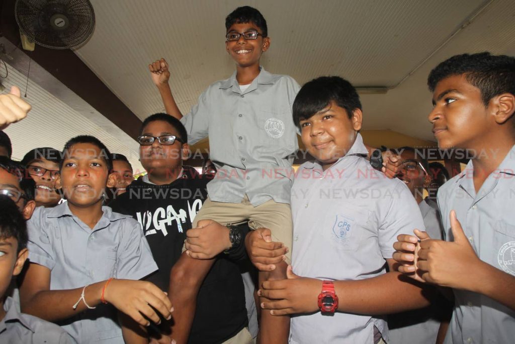 Manasseh Mohammed and his schoolmates of Canaan Presbyterian Primary School celebrate his placing as the third top performing student in the SEA exam.