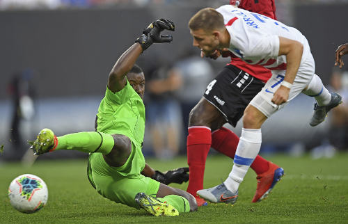 TT goalkeeper Marvin Phillip blocks an effort from US midfielder Paul Arriola during Saturday's match. (AP Photo)