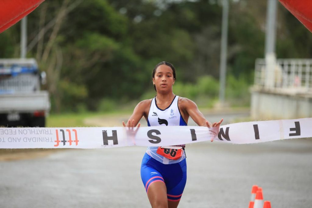 Makaira Wallace of St Joseph’s Convent Port of Spain crosses the finishline, during the TTTF Secondary Schools Triathlon Championships at the National Aquatic Centre, Balmain, Couva on Sunday.