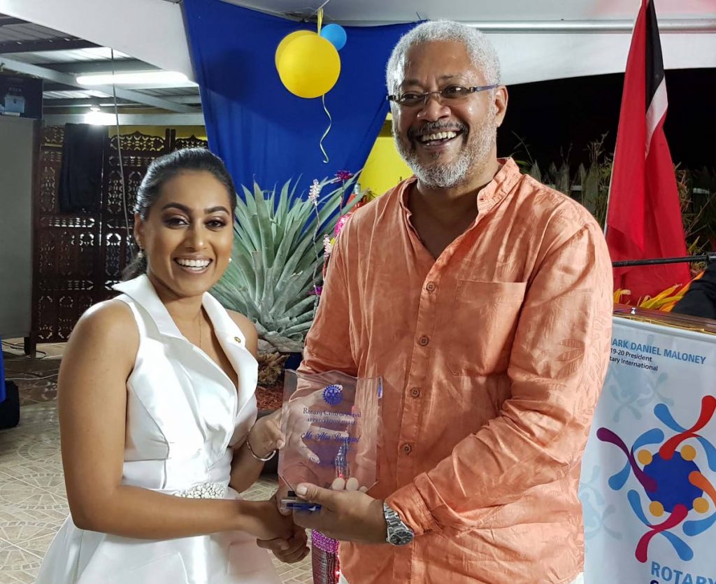 Outgoing president Narda Ramkissoon present Afra Raymond with a token of appreciation after his address at the Penal Rotary Club handing over ceremony on Saturday night. PHOTO BY YVONNE WEBB