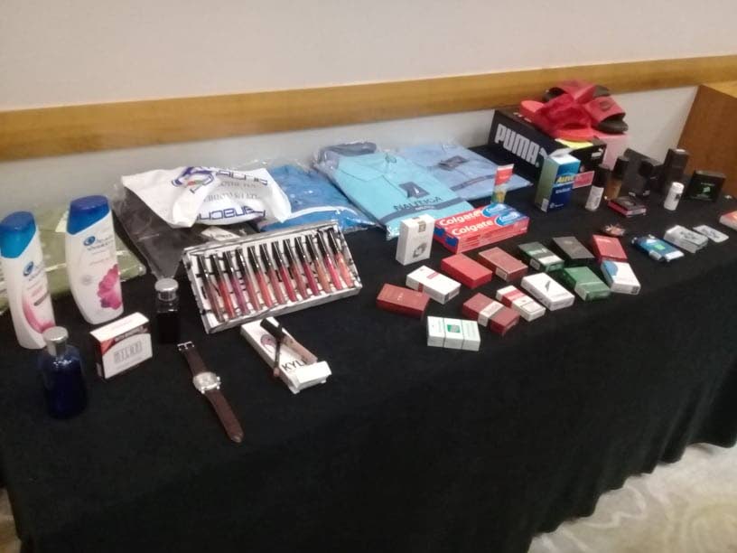 A table at the Hyatt Regency Hotel shows various counterfeit items which include fake toiletries, pharmaceuticals, clothing and accessories which were confiscated from local police exercises.  