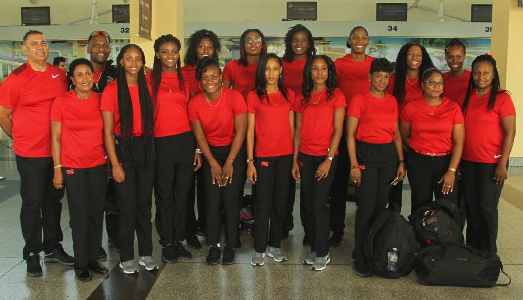 Members of the TT netball team and technical staff are all smiles prior to departing the Piarco airport yesterday for Wales for a training camp ahead of the upcoming International Netball Federation World Cup, to be held in Liverpool, England. Photo by Roger Jacob
