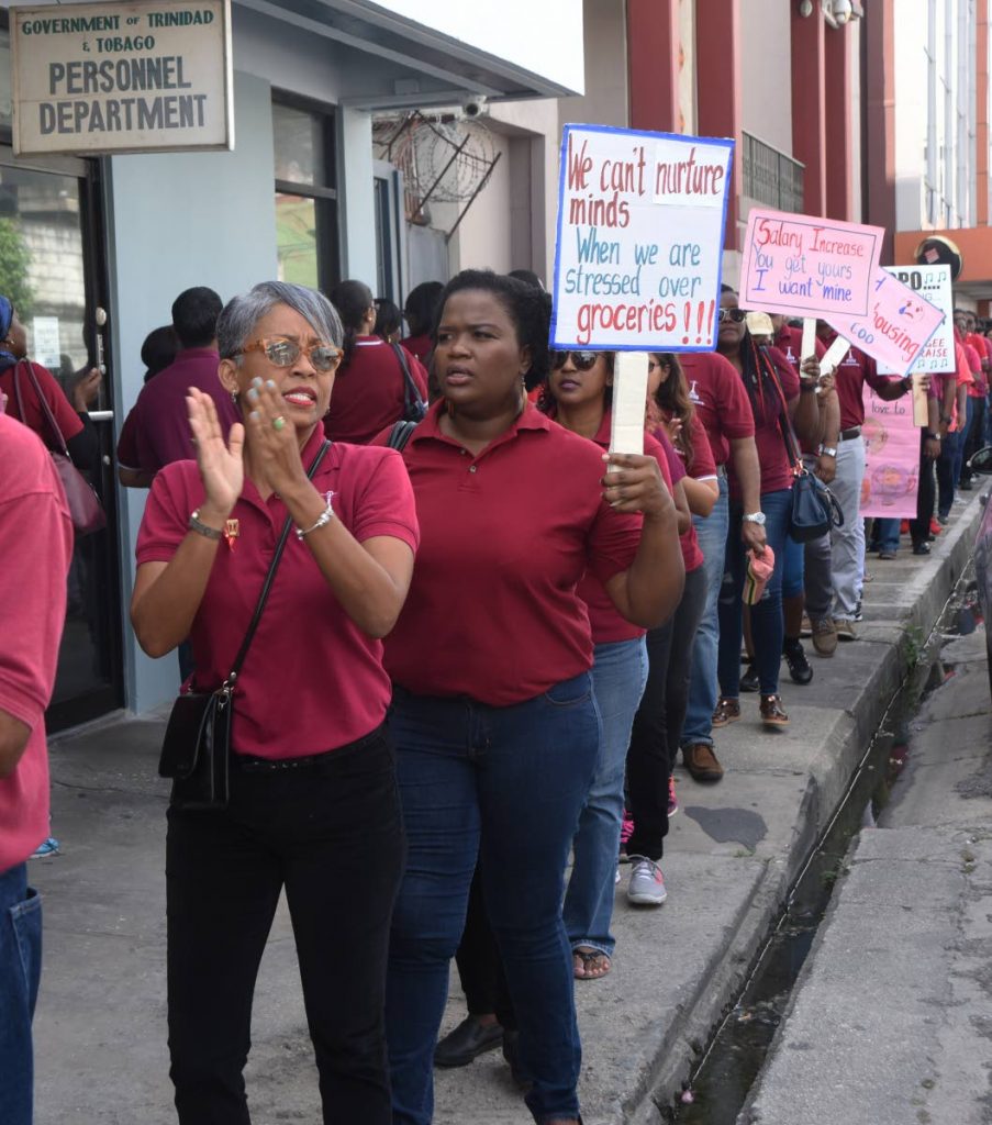 SEE ABOUT US: Teachers march outside the office of the Chief Personnel Officer on St Vincent Street, Port of Spain on Wednesday.   
PHOTO BY KERWIN PIERRE