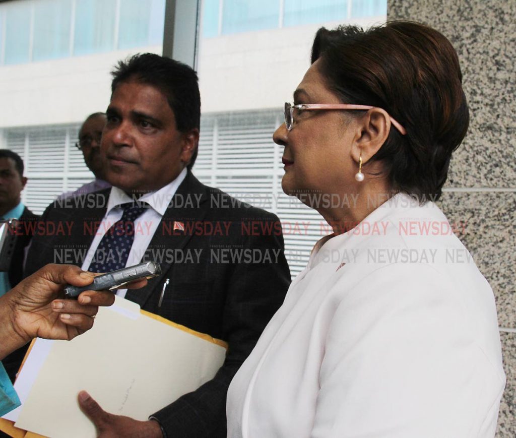 Opposition Leader Kamla Persad-Bissessar and Oropouche East MP Dr Roodal Moonilal speak with media outside Parliament in Port of Spain, on Wednesday. PHOTO BY ANGELO M MARCELLE