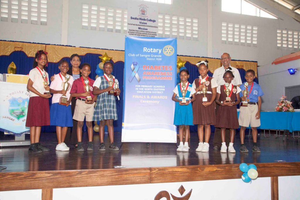 Diabetes Awareness Programme director, Dr Balmattee Sukha and Sangre Grande Rotary Club president Mervyn Ali, with the top students from each category.