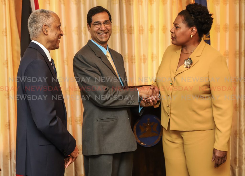 President Paula- Mae Weekes congratulates Peter Ramadar on taking oath of office as a judge in the CCJ at Presidents' House.

Photos: Jeff K Mayers