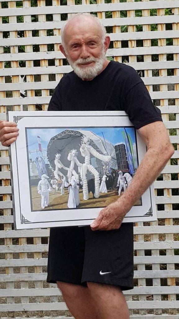 Peter Minshal poses with framed photo of his Callaloo Company's  presentation at the North Coast Jazz which was published in the Newdsay on May 31.