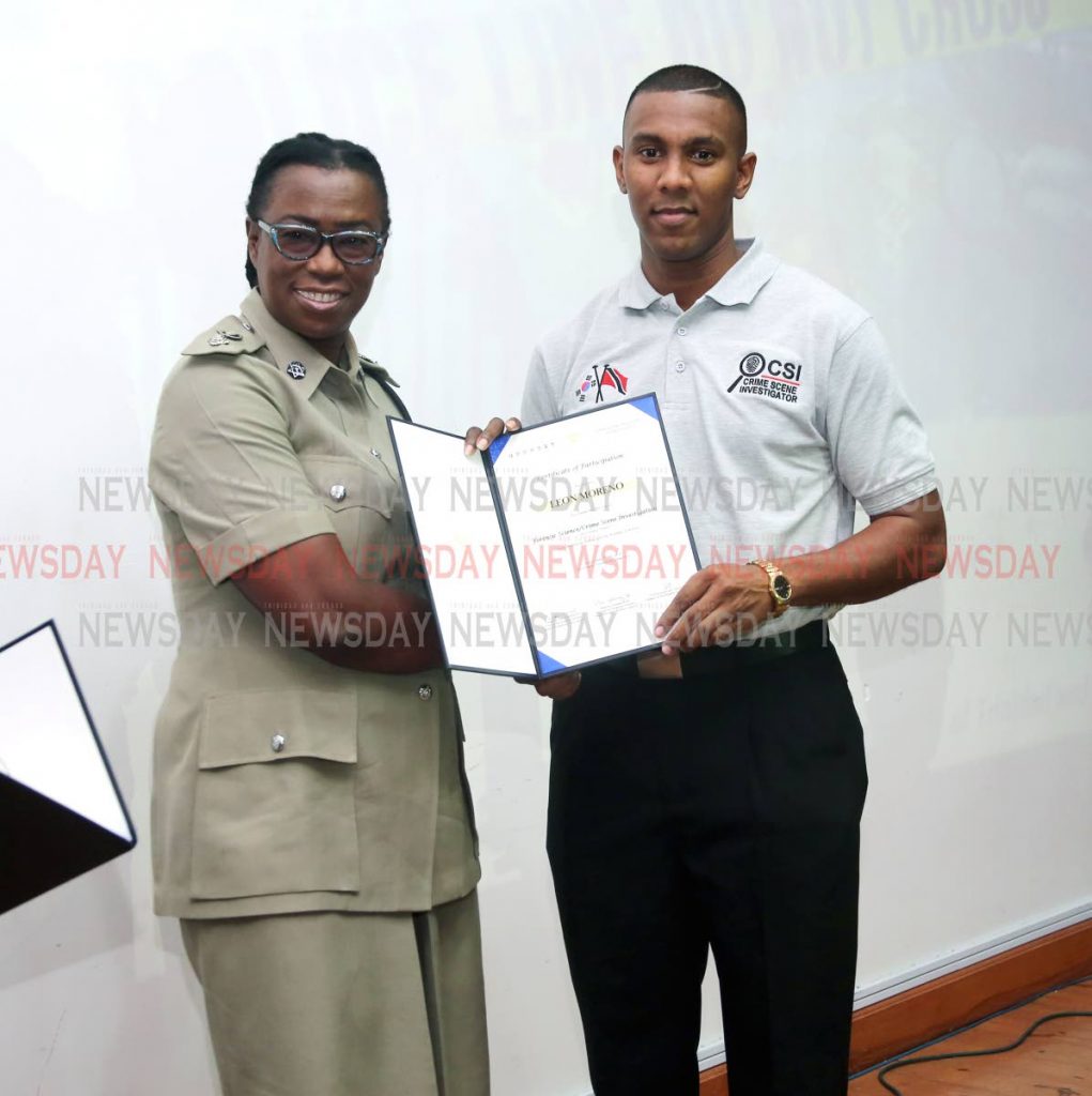 ACP Floris Hodge-Griffith presents Leon Moreno with his certificate.  PHOTO BY SUREASH CHOLAI