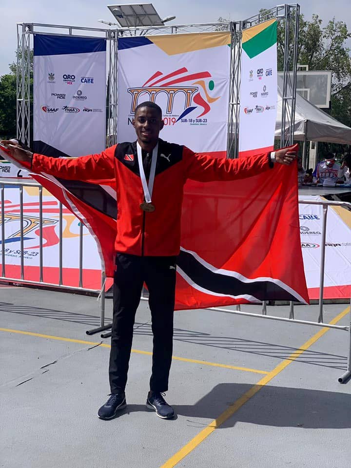 TT long jumper Andwuelle Wright with his NACAC U-23 gold medal and national flag in Mexico yesterday. PHOTO COURTESY DEXTER VOISIN FACEBOOK PAGE 