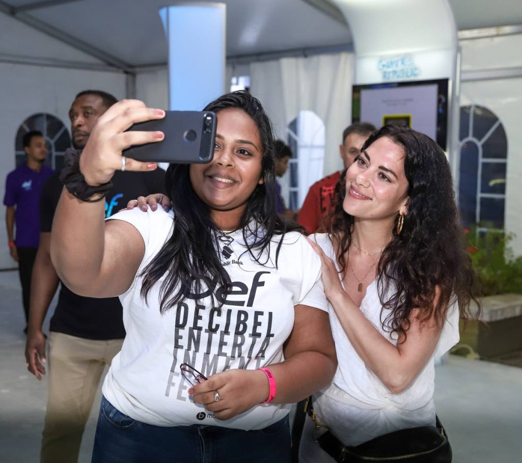 Israeli actress Inbar Lavi, right, star of the TV series Lucifer, takes a photo with a fan at the RBL Decibel entertainment festival, Queen's Hall, St Ann's on Friday. PHOTO BY JEFF K MAYERS
