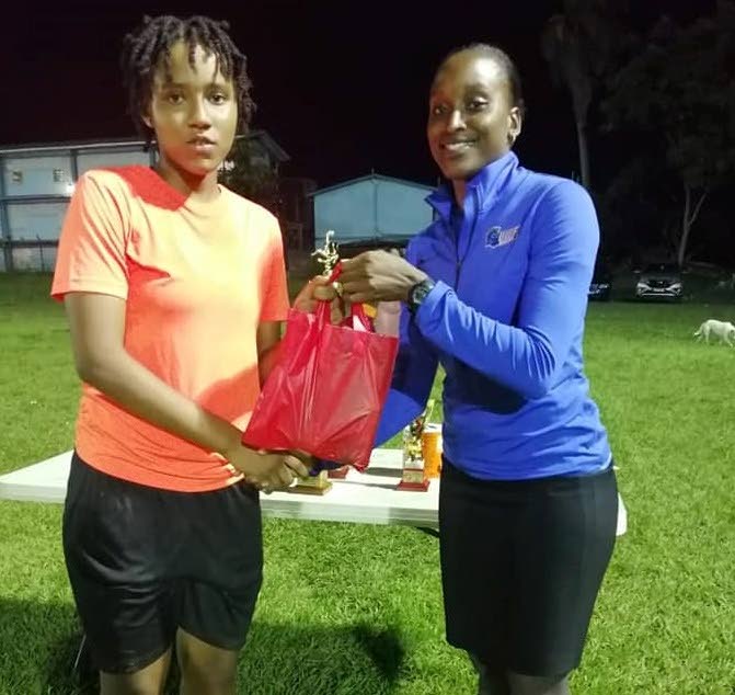 Moenesa Mejias, left, receives the match MVP award from Anastasia Prescott, following the final of the Concept Coaching Under-20 Women’s Tournament on Friday. 