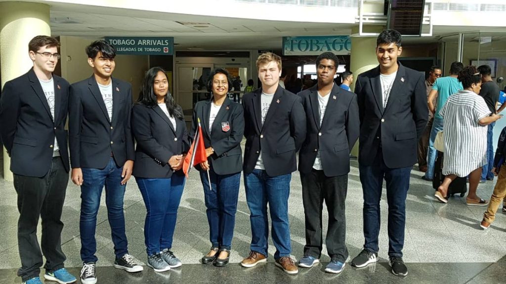 TEAM T&T: From left, students Justin Llanos, Rahul Gopeesingh, Celine Roodal, Team TT leader Dr Indra Haraksingh, Alex Adams, Joshua Davis and Rajeev Gopeesingh at Piarco Airport on Sunday shortly before they left for England to participate in the International Math Olympiad. PHOTO COURTESY TT MATH OLYMPIAD