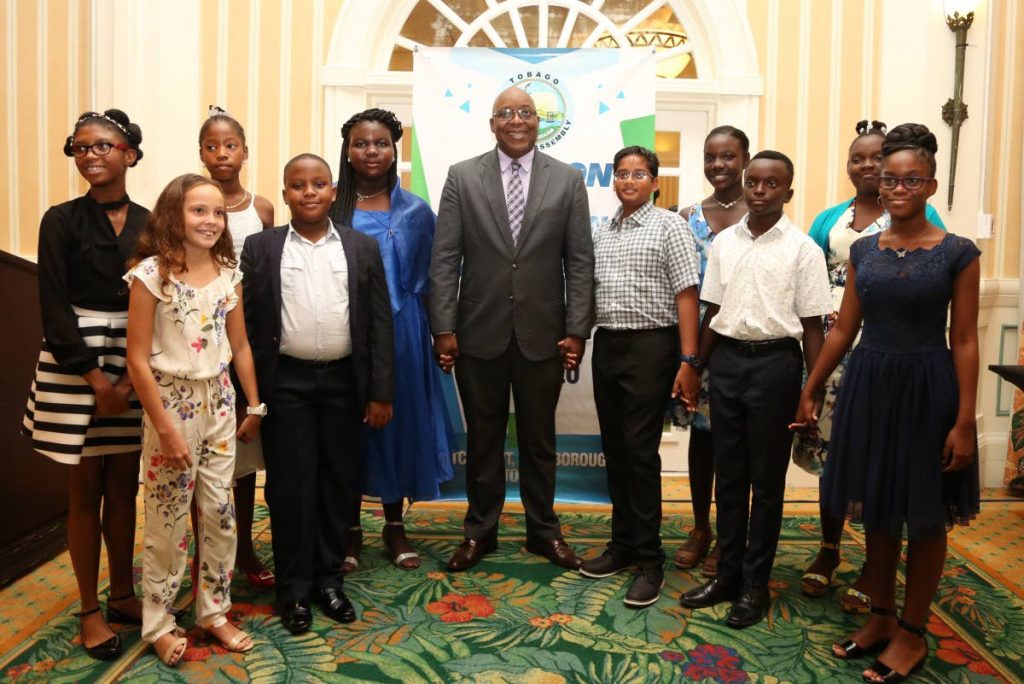 Chief Secretary Hon. Kelvin Charles (C) is flanked by the Top 10 SEA Students in Tobago. L-R back row: Brianna McPherson, Belle Garden AC; Adanna Rodriquez, Buccoo Government Primary; Daniella Taylor, Bethesda Government Primary; Sebastian Rampersad, Buccoo Government Primary; Xhane Gray, Signal Hill Government Primary; Achelle Melville, Signal Hill Government Primary.  L-R front row: Jade Llanos, Private Candidate; Kaelan Bynoe, St. Nicholas Private Primary and Brandon-Mark Browne and Jaden Roberts of the Pentecostal Light & Life Foundation Primary.