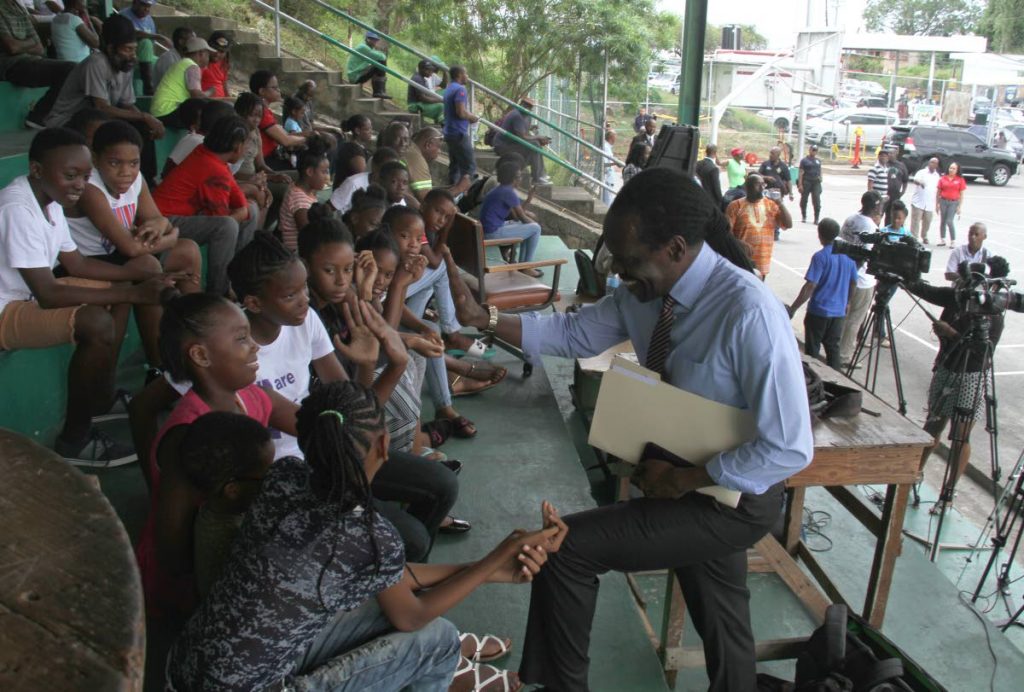 Laventille West MP Fitzgerald Hinds greets residents during a public meeting held at the St Barbs Basketball Court, Laventille, yesterday.