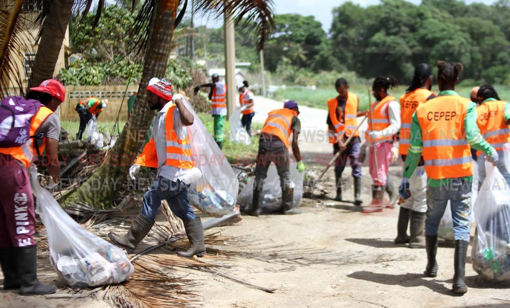 CEPEP workers clean the Manzanilla Beach as part of a coastal clean-up initiative by the organisation. Photo by Angelo Marcelle