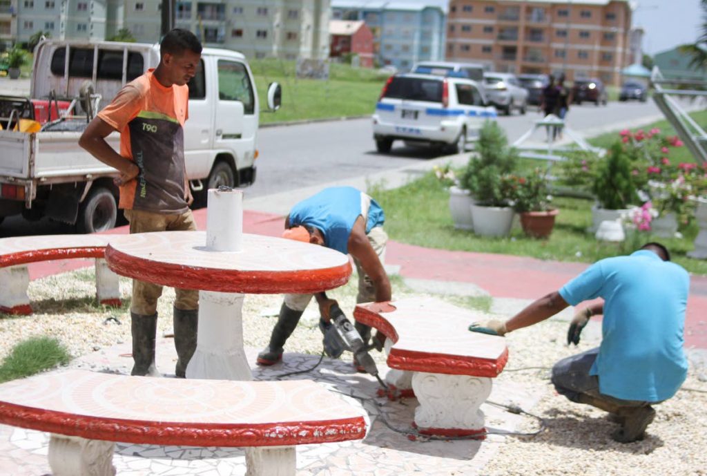 Contractors working on behalf of the HDC remove illegally constructed items at Oropune Gardens on Wednesday. PHOTO BY ANGELO MARCELLE