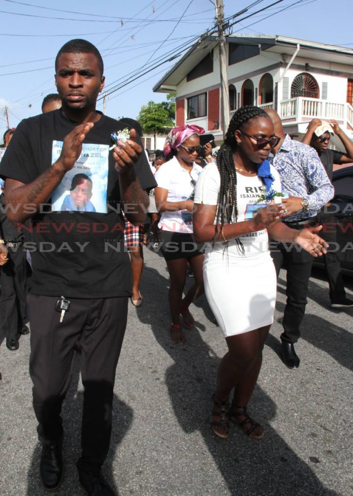 Kendel Hazel and Amanda Vincent in the funeral procession for their son Isaiah Hazel on Yallery Street, Couva on July 10. PHOTO BY VASHTI SINGH