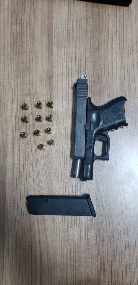 A Glock pistol and 11 rounds of ammunition that were confiscated from a 24-year-old Maloney man during a police exercise last night.   PHOTO COURTESY TTPS