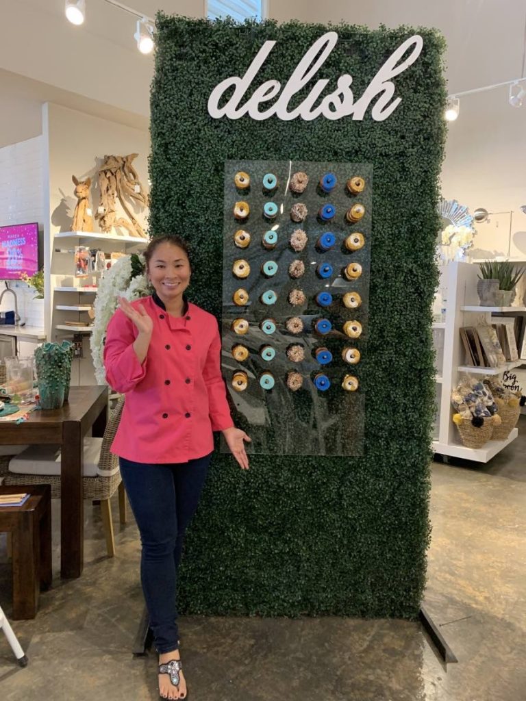 Elysée Gilbert and one of her doughnut walls. Photo courtesy Elysée Gilbert