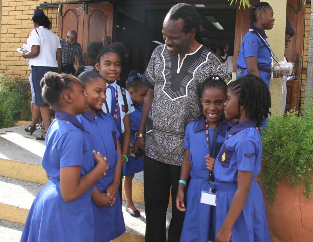 Laventille West MP Fitzgerald Hinds chats with delegates of the Girls’ Brigade, from left, Nathania Douglas, Jewel Arjoon, Naomie Orelien, J’len Roberts and Dasha Gormandy at the opening ceremony of the bi-annual Girls’ Jamboree of the Caribbean and Americas Fellowship at Church of the Open Bible, Laventille yesterday. PHOTO BY AYANNA KINSALE 