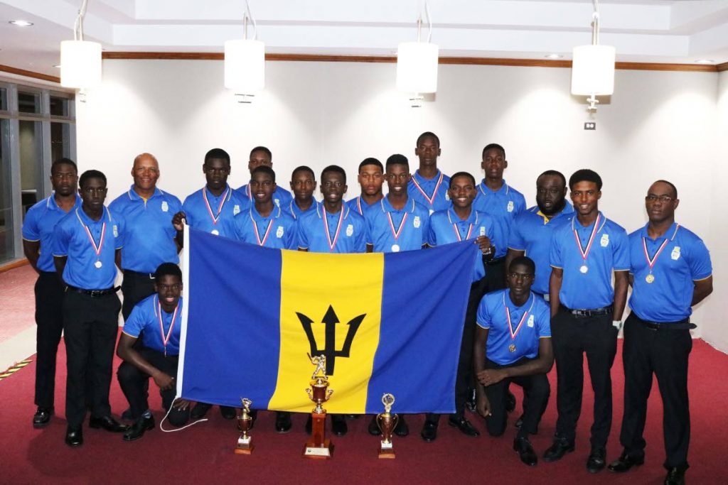 Barbados players and technical staff with their medals and trophies at the closing ceremony at the Brian Lara Cricket Academy in Tarouba, on Saturday. 