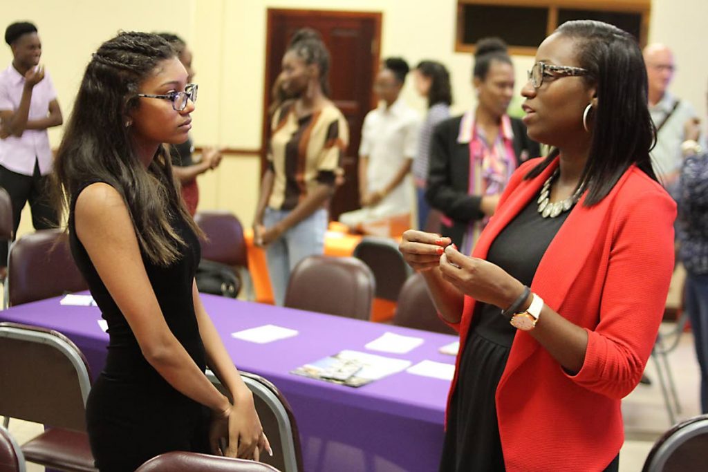  Families in Action CEO  Dionne Guischard speaks with YOUth Transitioning Programme student Tiffany Wint yesterday at the All Saints Anglican Church, Marli Street, Port of Spain. 