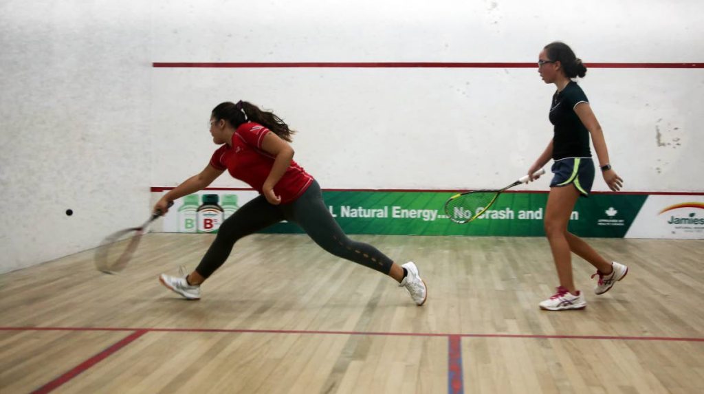 TT’s Nicola De Verteuil, left, and Jamaica’s Eleanor Hind in the girls Under-15 consolation playoff at the 2019 Junior Caribbean Area Squash Association (CASA) Championships. Hind won 11-8, 11-3, 9-11, 11-8. PHOTO BY SUREASH CHOLAI