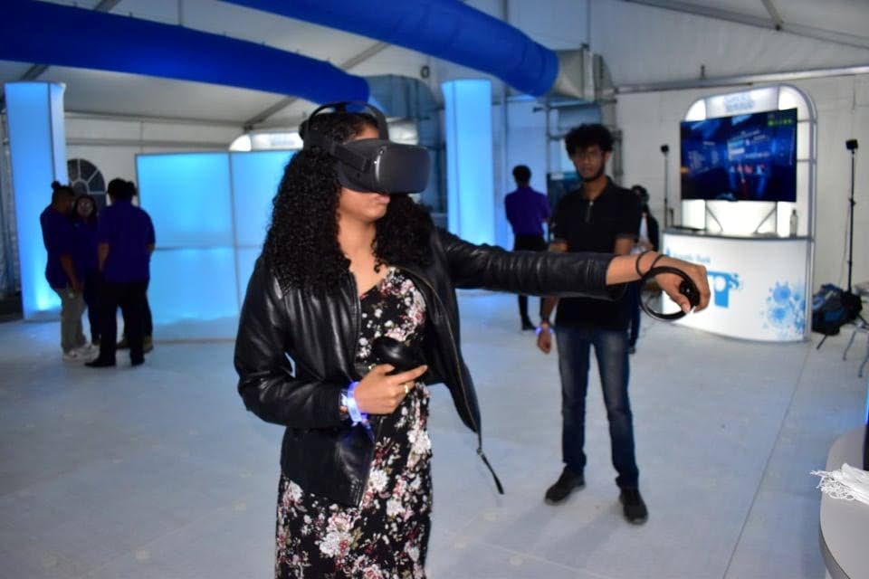 A woman playing a VR game at Decibel 2019 Gamer's Republic at Queen's Hall. Photo by Aneillio “Proto” Brazzier.
